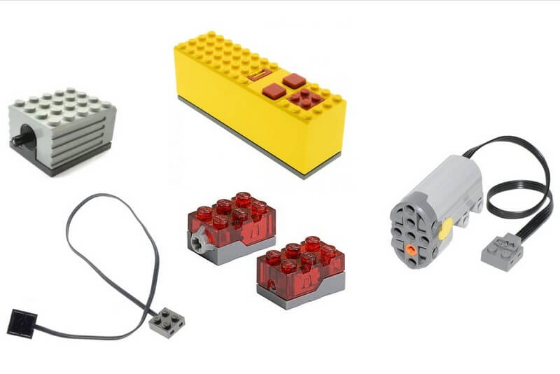 Elektrische Lego-Teile wie Kabel, Motoren und Lichtsteine.