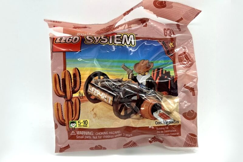 Polybag mit Banditen-Minifigur und einem Geschützwagen mit zwei Gewehren.