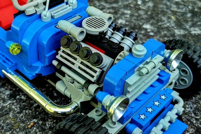 Motorblock aus LEGO-Steinen mit acht Zylindern und Chrome-Auspuffanlage.