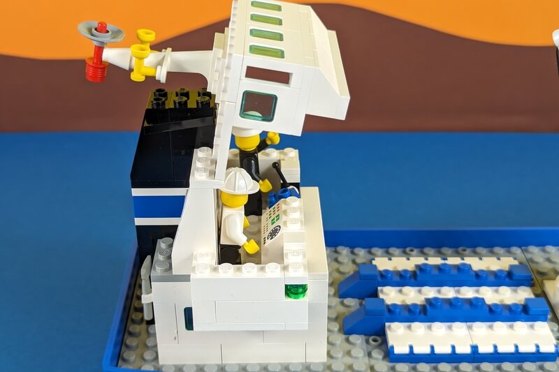 Aufgeklappte Brücke des Lego-Frachters mit Kapitän und Matrose.